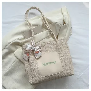 Stylish straw woven tote bag for women, large capacity casual shoulder bag with ribbon detail.