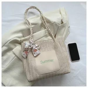 Straw woven tote bag for women, summer casual beige shoulder bag with scarf decoration.