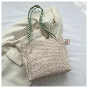 Casual straw woven tote bag with green braided shoulder straps, stylish large capacity bag.