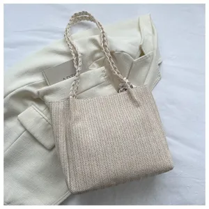 Woven straw tote bag for women, large capacity single shoulder bag, casual spring fashion design.