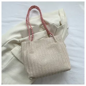 Chic woven straw tote bag for women, stylish beige shoulder bag with pink braided straps.