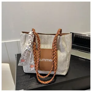 Large capacity straw woven tote bag with braided handles and stylish summer design for women.