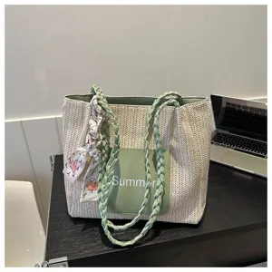 Woven straw tote bag for women, stylish summer shoulder bag with braided handles and scarf decor.