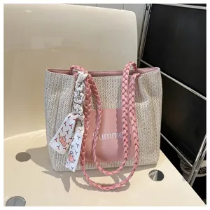 Woven straw tote bag detail, pink braided shoulder straps, Summer print pocket, scarf accent.