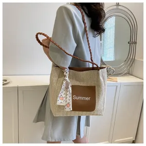 Woven straw tote bag detail, featuring brown pocket, summer style shoulder strap, casual.