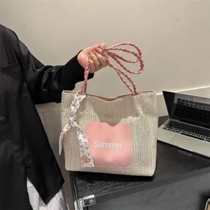 Stylish straw tote bag for women, large capacity woven shoulder bag with pink handles.