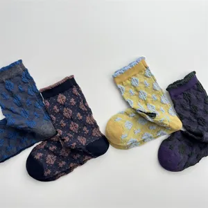 Detail view of retro floral textured mid tube socks, cute vintage cotton socks for women.