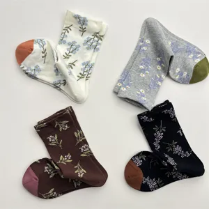 Detail view of retro botanical floral cotton mid-calf socks featuring colorful toes.