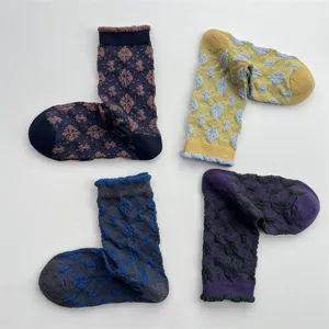 Detail shot showing the textured floral pattern and color-blocking design of the vintage cotton socks.