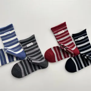 Korean style striped mid-tube socks with cute roll cuffs and a delicate label detail.