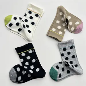 Women's cute polka dot mid-tube socks with contrast color design, soft cotton knit, sweet style.