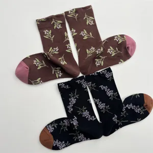 Detailed view of vintage floral cotton mid-tube socks featuring contrast color toes.