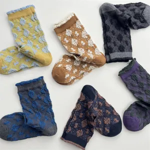 Detail view of Japanese retro cotton embossed floral mid-tube socks with cute ruffle details.