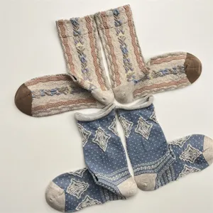 Close-up detail of vintage style floral and diamond patterned knit mid-tube socks for women.