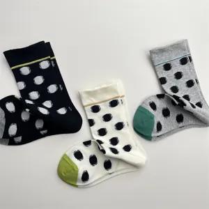 Korean style women polka dot mid tube socks detail, soft cotton knit material and contrast design.