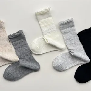 Detailed view of casual solid color mid-tube socks with ruffles and breathable mesh design.