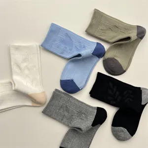 Comfortable solid color mid-calf socks with hidden bird jacquard design, soft cotton blend.