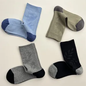 Detailed view of jacquard mid-calf socks with cute bird and leaf patterns in four colors.