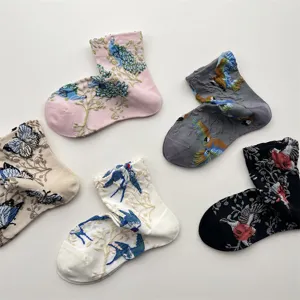 Detailed view of vintage cotton mid-calf socks featuring 3D embossed bird and butterfly embroidery.