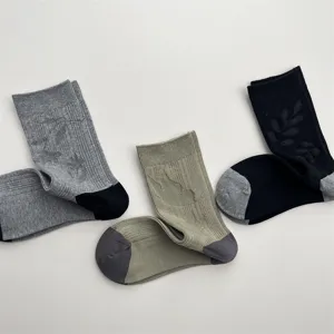 Detailed view of minimalist jacquard mid-tube socks, featuring subtle flying bird patterns.