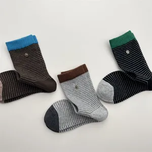 Korean style contrast color striped mid-tube socks with metal buckle for autumn and winter.