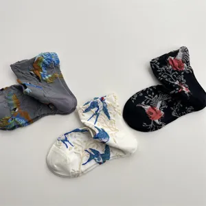 Detailed view of women's vintage relief socks featuring artistic bird and floral patterns.