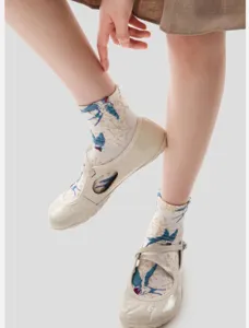 Detail view of vintage swallow floral embroidered cotton mid-calf socks for autumn winter.