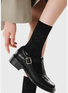 Black jacquard mid-calf socks with subtle bird pattern, minimalist fashion knit hosiery for women.