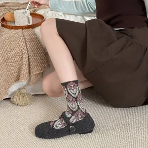Detail shot of vintage floral mid-tube socks paired with dark Mary Jane shoes.