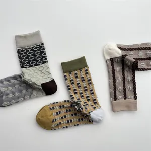 Details of women's cotton mid-tube socks with 3D embossed geometric pattern and chic color block lines.