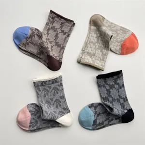 Detail view of Japanese vintage retro color-blocking geometric pattern cotton mid-tube socks.