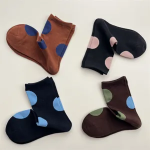 Detailed view of colorful polka dot mid-calf socks, featuring cute round patterns and soft cotton.