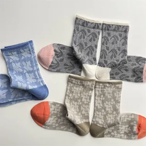 Detailed view of vintage patterned mid-calf socks with contrast color toes and heels, soft fabric.