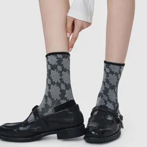 Detailed shot of Japanese retro geometric patterned mid-calf socks paired with classic loafers.
