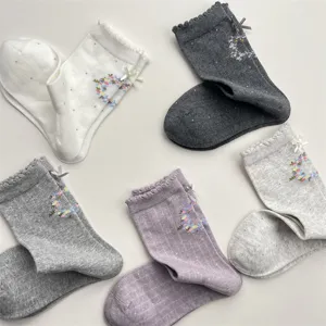 Detailed view of sweet Korean style floral print mid-calf socks with bows and ruffles.