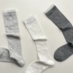 Detailed view of women's sheer lace trim knee high socks, breathable summer hosiery.