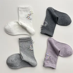 Korean sweet bow cotton mid-tube socks with floral pattern, cozy autumn winter hosiery details.