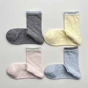 Detailed view of breathable mesh mid-tube socks with hollow-out vine pattern and color-blocking.