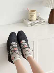 Chic floral mesh socks and woven flats combination, perfect for spring and summer comfort style.