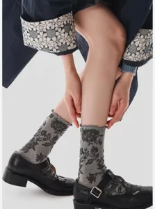 Detailed close-up of retro floral mid-calf socks with lettuce edge, vintage style.
