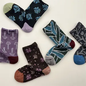 Detailed shot of retro embossed floral pattern cotton mid-tube socks, set of five vibrant colors.