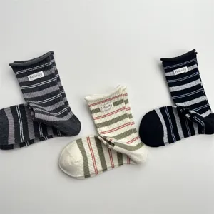 Detailed close up view of Korean style rolled cuff colorful striped socks with fabric label