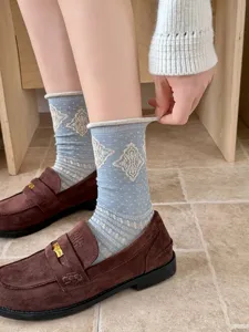 Detailed view of women's vintage argyle patterned cuffed mid-calf socks, cozy cotton knit.