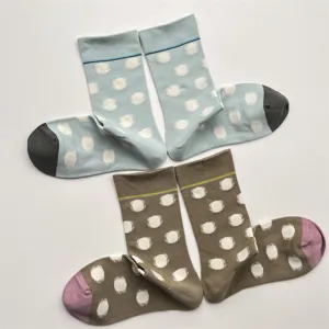 Close-up detail of cute Korean style contrast polka dot socks in blue and khaki cotton fabric.