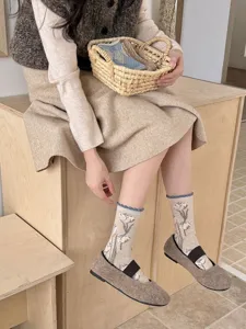 Japanese retro pastoral style women's mid-tube socks featuring cute tulip patterns and rolled edges.