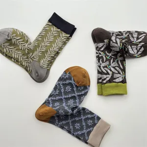 Close-up of Japanese vintage embroidered cotton socks featuring wheat and bird patterns.