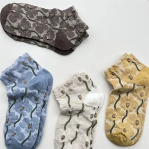 Detail view of the floral embroidered short socks, showcasing texture and vintage design.