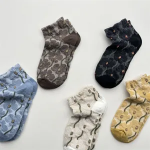 Detailed view of retro floral ankle socks with 3D embossed flower patterns, breathable cotton.