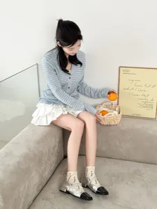 Detailed shot showcasing floral print short socks paired with elegant silver shoes on model.