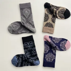 Close-up detail of retro damask floral embossed cotton mid-tube socks, autumn winter wear.